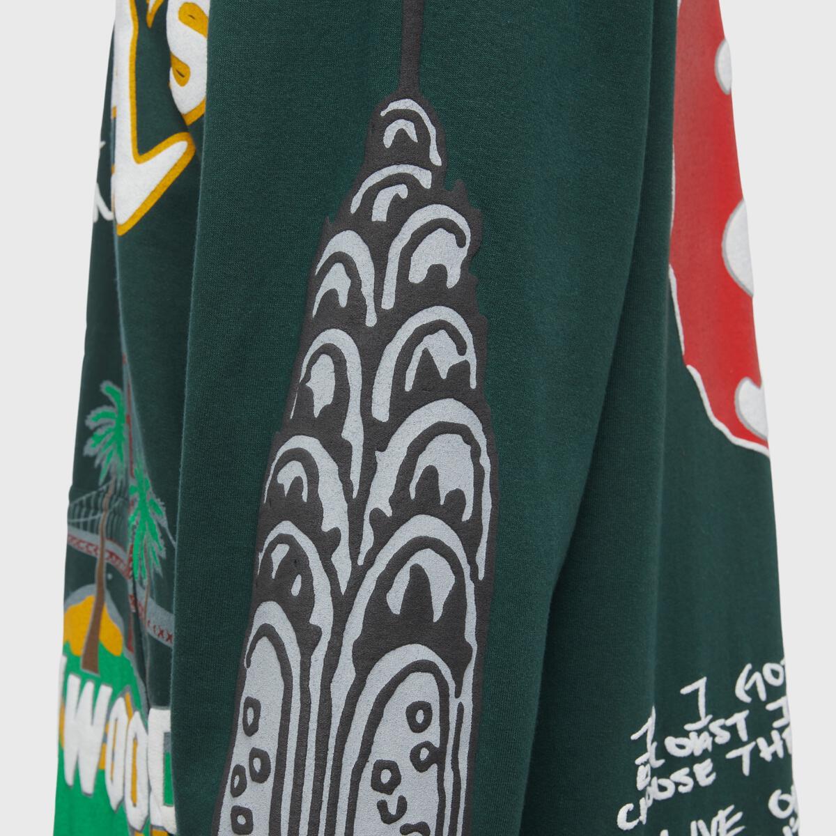 Unisex forest green hoodie showcasing the Homme + Femme Cali to NYC design (HFSS2022137-3)