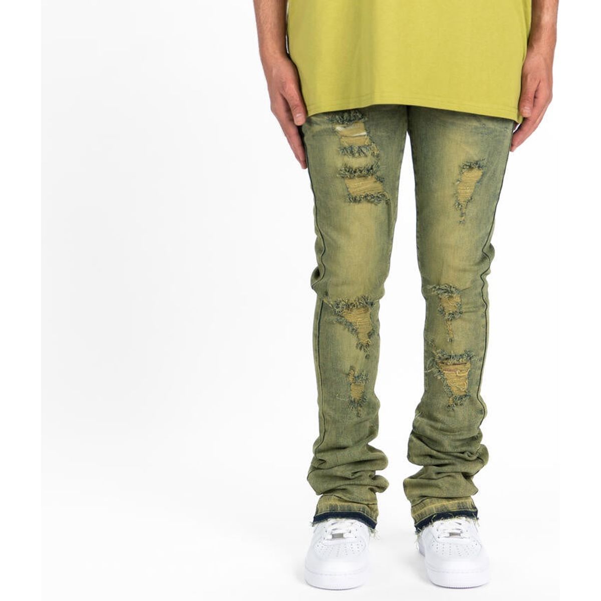 Close-up photo of PHEELINGS Getting There Fern Green Flare Stack Denim jeans, featuring a stylish and unique flare design in a rich green color