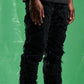 Close-up of Embellish Jenson Black Ripped Denim Jeans with distressed details and frayed edges for a rugged look